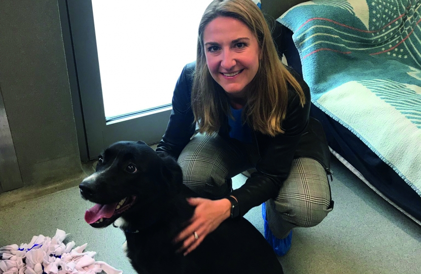 Kim with a Black Labrador Retriever in a 'pet-friendly' house.