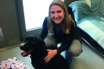 Kim with a Black Labrador Retriever in a 'pet-friendly' house.