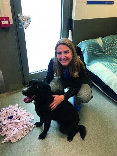 Kim with a Black Labrador Retriever in a 'pet-friendly' house.